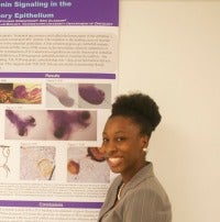 Student showing a poster with research